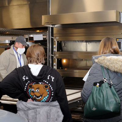 Chef Todd M. Keeley, assistant professor of baking and pastry/culinary arts, provides an oven demo in the baking and pastry lab. He was joined for a portion of the tour by Rebecca E. High, laboratory assistant for food and hospitality/culinary and a Senior Resident Assistant, who supplied a valuable student perspective for potential enrollees. (High, of Willow Street, is working toward a bachelor's in applied management to add to her 2021 associate degree in baking and pastry arts.)