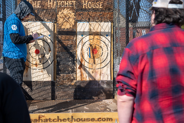 A Hatchet House employee tabulates the scores of two college competitors.