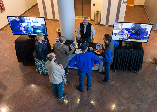 Among visitors to the welding demo are (gathered at left) Bradley M. Webb, dean of engineering technologies; and assistant deans Ellyn A. Lester, construction and architectural technologies, and Kathleen D. Chesmel, materials science and engineering technology.
