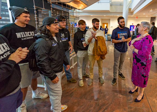Members of the lacrosse team visit with the president, relaying that their collaborative fundraising efforts topped $16,000.