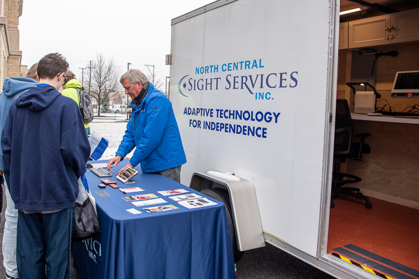 Brandon De Arment, technology specialist with North Central Sight Services Inc., discusses adaptive technologies at the nonprofit’s mobile assistive technology trailer.