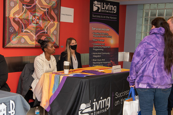 Representatives with the Williamsport-based Living Unlimited, Inc. converse with a mother and son in Wrapture, a college dining unit that was utilized for the vendor tables. 