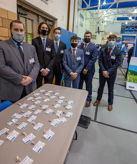 Before a table full of professional nametags for their student colleagues, members of the Construction Management Association impressively mount a full-court press!