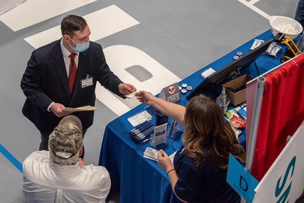 Dylan B. Whitmoyer, a freshman in construction management from Muncy, successfully navigates his first Penn College Career Fair – and receives a business card for his efforts. 