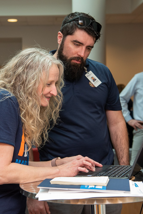 Erin S. Shultz, career events manager, helps General Services' Brian J. Coppadge, a second-shift facilities services shift manager, log his donation.