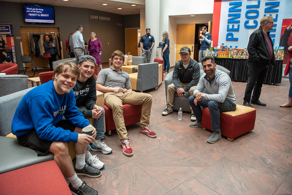 Wildcat wrestlers enjoy socializing with their former coach, Jamie R. Miller (right).