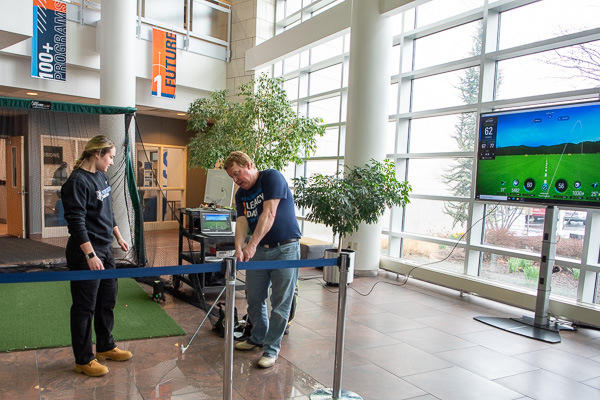Chris S. Macdonald, assistant director of corporate relations, offers his pro-shop expertise to onlookers – including Wildcat soccer player Nicole R. Lichtinger, of Erie, an emergency management and homeland security student.