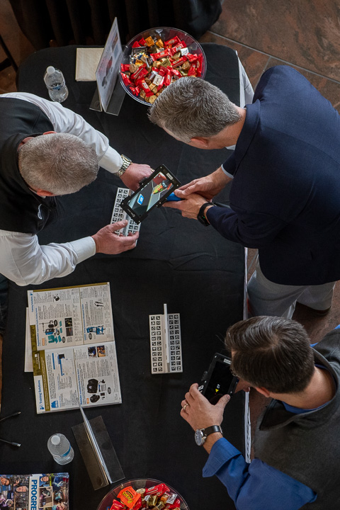 A bird’s eye view of Reed (top right) trying his hand at the welding simulator, assisted by Miller Electric's Rick Conrad, a field application engineer and college alumnus.