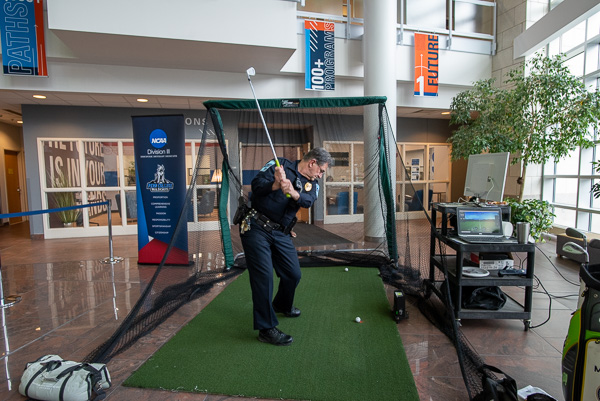 Penn College Police Chief Chris E. Miller exhibits a winning backswing, duty belt and all. 