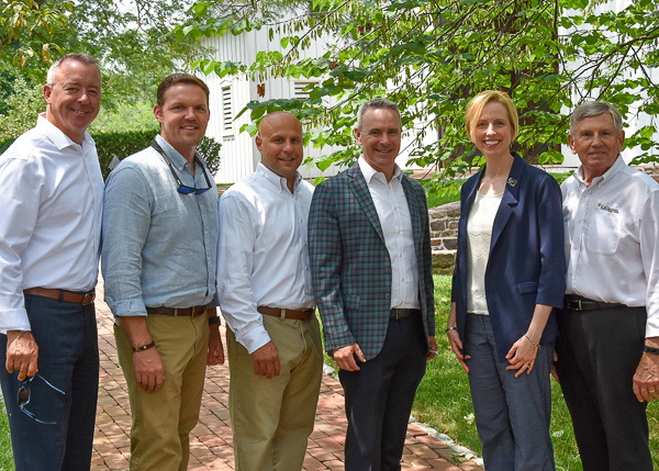 Elizabeth A. Biddle, Pennsylvania College of Technology's director of corporate relations, joins members of the Allan Myers team in marking the company's longtime generosity on behalf of students. From left are Bob Herbein, executive vice president, corporate services; Curtis Wargo, senior project manager (Pennsylvania); David Giumento, senior project manager (Maryland); Brock Myers, executive vice president, operations; Biddle; and Bob Capps, retired director, craft development. Wargo (2005) and Giumento (2003) are graduates of the college's four-year construction management major. (Photo by Karen Dobson, Allan Myers)