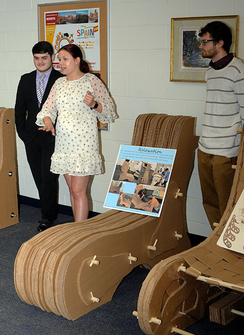 A gracefully slim entry (with dowels and decorative side pieces), which used 49 of the allowable 50 pieces of corrugated cardboard, is presented by its creators. From left are Andy M. McMullen, of Hollidaysburg; Amanda F. Ritter, of Williamsport; and Steven A. Adams, of Watsontown.
