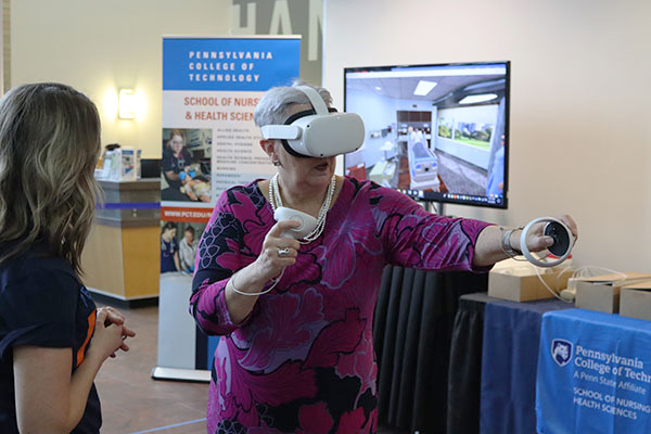 A key component of the Gilmour ethos is a willingness to put herself in the shoes of students. In addition to stints as golfer and welder during Thursday's festivities, she took a VR tour of a hospital room.