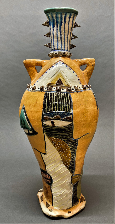 An untitled work by Stabley: large vessel form, coil constructed, soda fired stoneware; decorated with flashing slips, stains, underglazes and glazes, 20 inches by 13 inches by 8 inches.