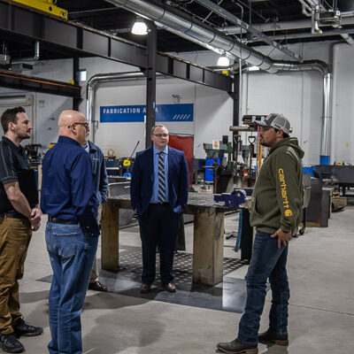 Robby R. Smith (right), of Mount Wolf, enrolled in welding and fabrication engineering technology, leads a lab tour.