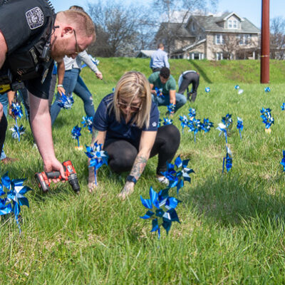 Old Lycoming Twp. Police Office Robert Mausteller assists Richardson with the logistics of planting. 