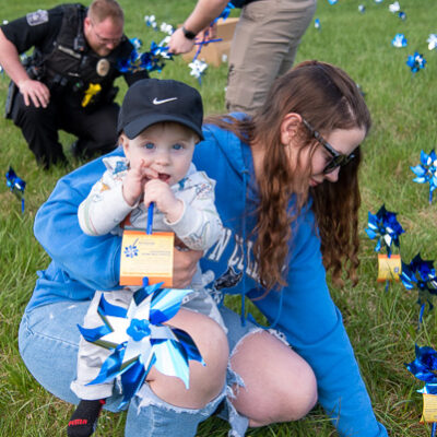Blue eyes and blue pinwheels! Human services & restorative justice student Alicia Charlene Dobbs, of Williamsport, enjoys the spring outing with her son. 