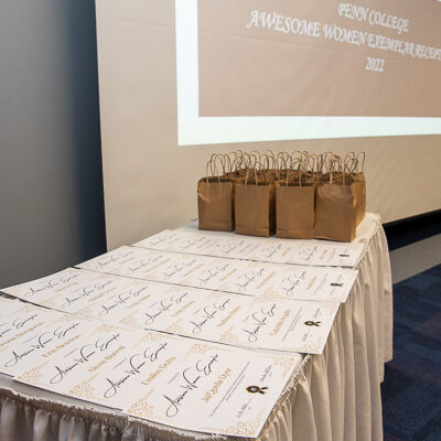 Certificates and gifts fill a skirted table, destined for this year's "Awesome Women."