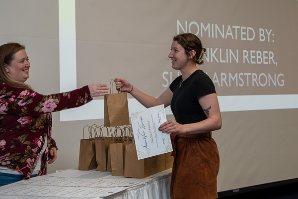 Suggested by two members of the building construction faculty is the ConCreate Design Club's Madison L. Kistler, accepting her gift bag from Blaise E. Marshall, Residence Life hall coordinator for Rose Street Commons. "Women have made great strides in the construction fields," one of those nominators said, "and students like Madison ... are leading the way. (She) is a true leader among her peers. Her natural curiosity and knowledge are infectious."