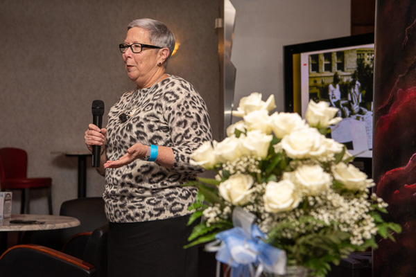 With her vase of roses in the foreground, Gilmour shares her gratitude with the SGA alumni.