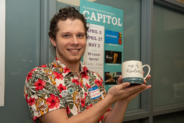 A cup of kindness is held by Cody R. Englehart, human services & restorative justice. The mug was among items in a “wellness gift basket” being given away by the Human Services and Restorative Justice Club.