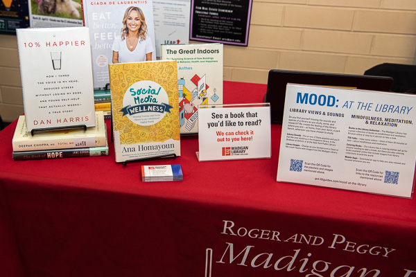 An array of self-help topics fill The Madigan Library table.