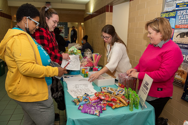 Play-Doh, bubbles and coloring sheets are among stress-relieving fun offered by LEAP Center staff Christie A. Bing Kracker (far right), director, and Kaysey L. Beury, adviser.