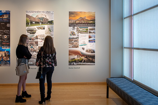 Visitors discuss students’ explorations of a Guggenheim Museum in Helsinki.