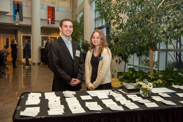 On hand to check in guests and mingle are College Relations Student Assistants Rudy C. Shadle and Natalie K. Lincalis.