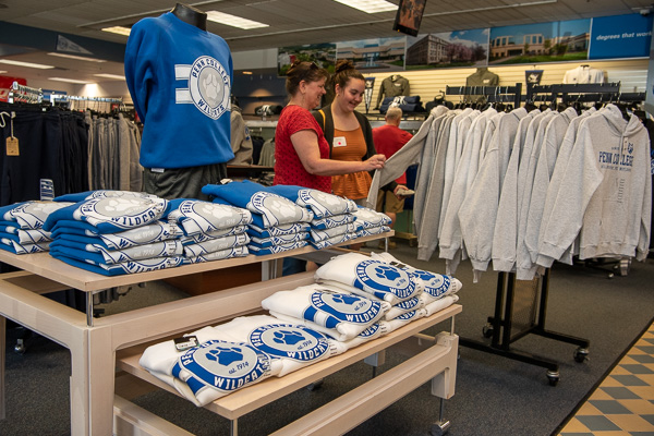 Sarah L. Pennay and her mother consider Wildcat merchandise available in The College Store. Pennay, of Liverpool, is pondering the nursing major. 