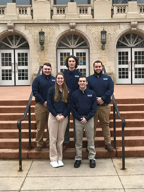 Pennsylvania College of Technology's entry in the Associated Builders and Contractors' 2022 Student Chapter Construction Management Competition, held in mid-March in San Antonio, reconvene for a team photo outside the college's Klump Academic Center. Clockwise from front left are Danielle E. Malesky, of Biglerville; Cody J. Smith, of Honesdale; Conor B. Laraia, of Chambersburg; Mike R. Miller, of Montgomery; and Rudy C. Shadle, of Mechanicsburg.