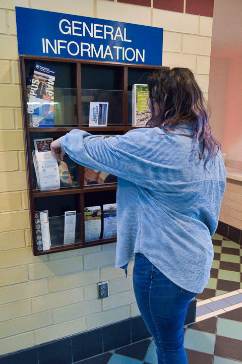 Sarah A. Hornberger, a business administration: banking & finance concentration student from Mifflinburg, stashes a bird in an informational display case. 
