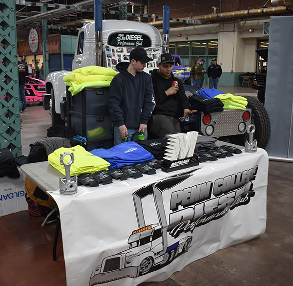 Solly (left) and Spinosa work the display table, selling club apparel and other merchandise.