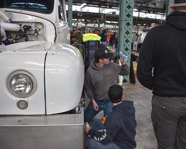 Solly (in foreground) and Brubaker clean the wheels and tires before the event.