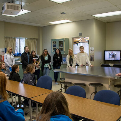 Scott A. Geist, director of surgical technology, talks with high school visitors about the program.