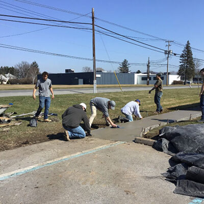At General Services' off-campus headquarters – the nerve center for maintenance, enhancement and preservation of college facilities – students upgrade a sidewalk ...