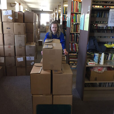 Miller pushes a full cart through the library sorting area.