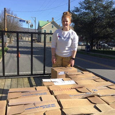 Cordrey takes a breather while offloading boxes from a flatbed trailer.