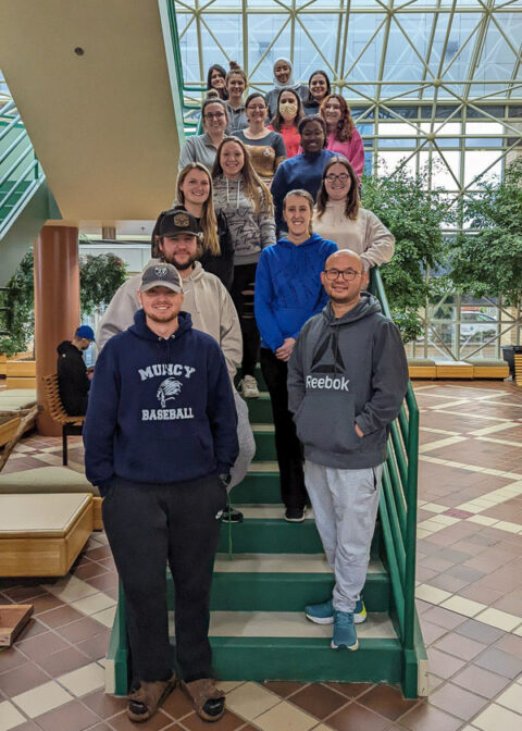 Nursing students who offered a series of employee wellness sessions line the Breuder Advanced Technology & Health Sciences Center atrium staircase.
