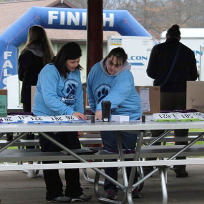 Hunter (left), among the volunteers at event signup, diligently keep tabs.