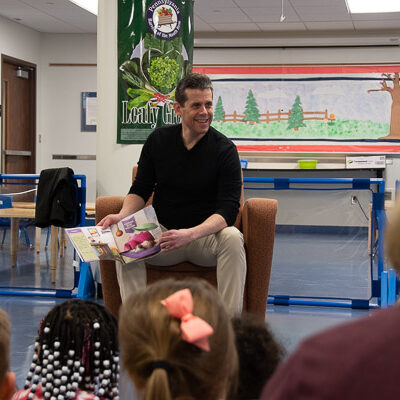Tom Speicher engages with children while reading “A Week With Waffles.”