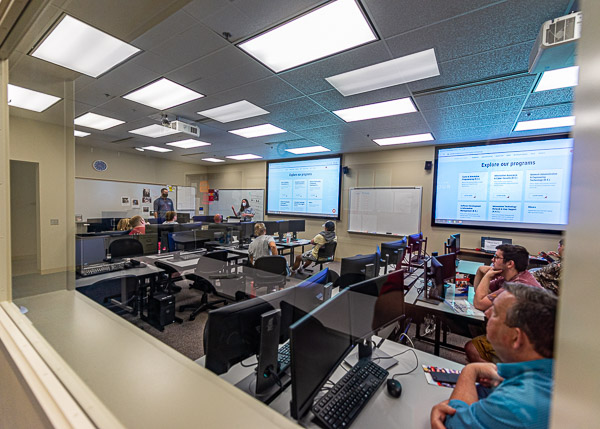 Two more helpful faculty members – Allen Heimbach, instructor of computer information technology, and Alicia L. McNett, assistant professor of computer information technology – offer an illuminating overview in the gaming lab.