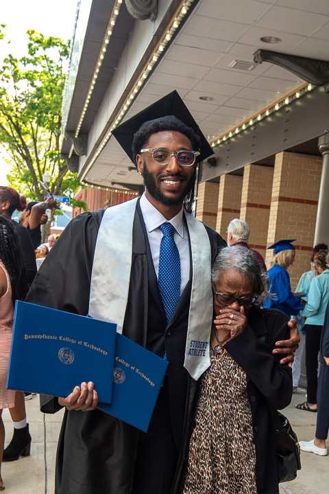 Jesse L. White with his grandmother – who was moved to tears by the moment. The Wildcat basketball player added a bachelor's in business administration: management concentration to an earlier associate degree in business management.