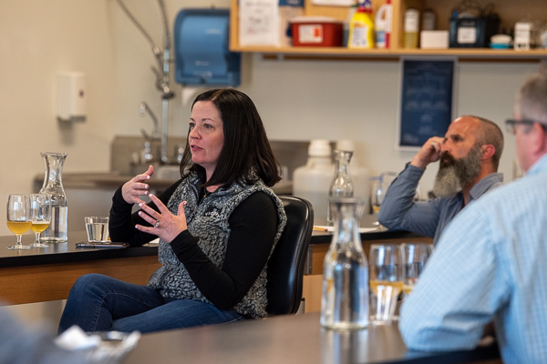 Karen Brownell, director of brewing operations at Victory Brewing Co., offers her insights. At right are Rob Kathcart, head brewer at Wellsboro House Brewery, and David S. Richards (with his back to the camera), Penn College physics professor and a home brewer.