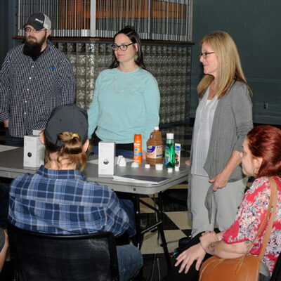 Engaging ambassadors from West Pharmaceutical Services Inc. showcase some of the products manufactured at their various locations and talk with families about career opportunities. From left are Ronald Long, Karen Daugherty and Heather Allison.