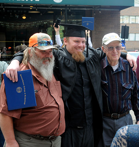 Charles R.A. Howard, of Williamsport, who earned a four-year degree in civil engineering technology, meets up with family after the proceedings.