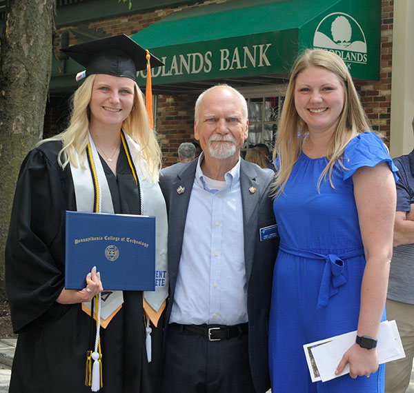 Faculty athletics representative Tom A. Zimmerman with two Wildcats: the just-graduated Kelly Ann Williams and her sister, Hanna J., a 2018 alumna in industrial & human factors design and studio arts. The Williamses both played soccer and tennis during their Penn College years.