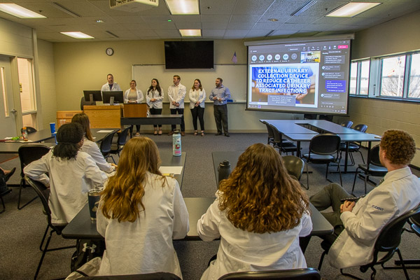 Before an audience of their Penn College classmates, plus a virtual audience stationed at two universities and Geisinger, students present their research: “External Urinary Collection to Reduce Catheter-Associated Urinary Tract Infections.”