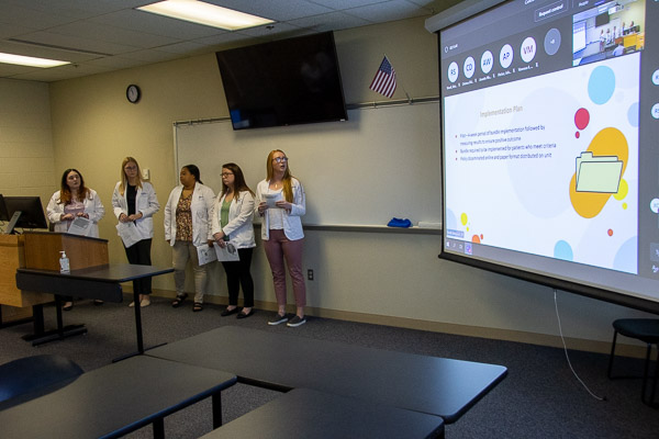 Students present an implementation plan for the results of their work on "The Effects of Prone Positioning in Acute Respiratory Distress Syndrome."