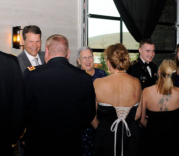 President Gilmour greets guests as part of a traditional receiving line, alongside Chip Edmonds (left), executive vice president at Lycoming College, and Ward (right), among the Penn College seniors honored later in the evening. The two colleges are joined in the Bald Eagle Battalion by Lock Haven and Mansfield universities.