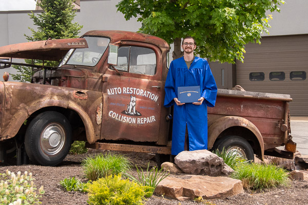 Nash D. Berfield, of Jersey Shore, who earned dual degrees in collision repair technology and automotive restoration technology, finds an appropriate farewell backdrop.